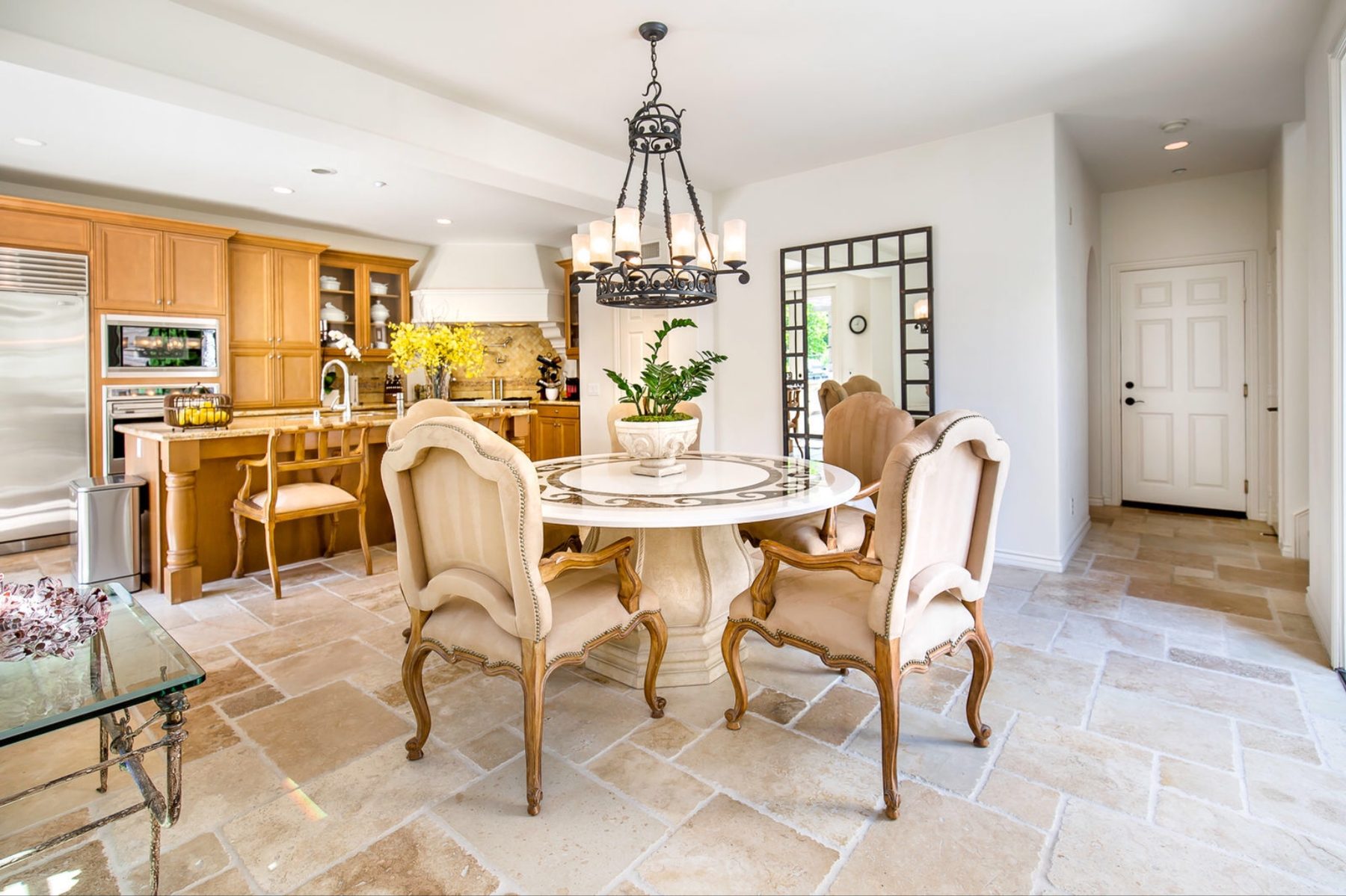 Formal dining beneath a hand-forged iron chandelier