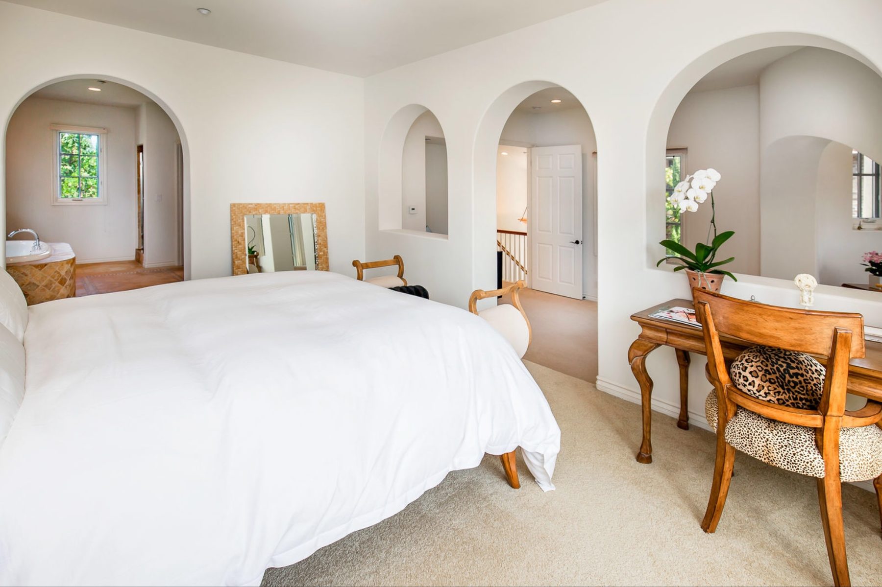 Master suite seen through arched openings