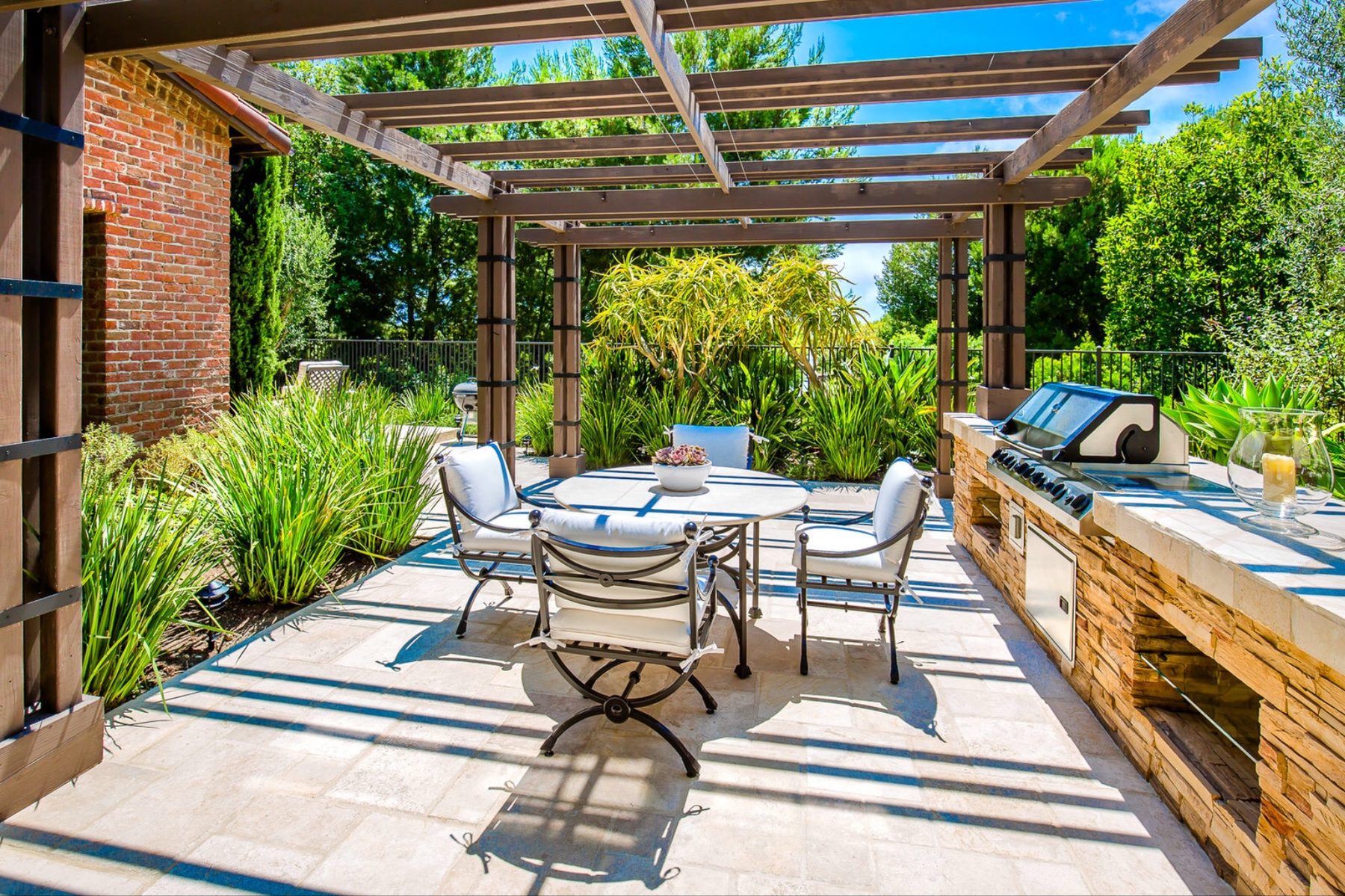 Outdoor kitchen beneath a timber pergola